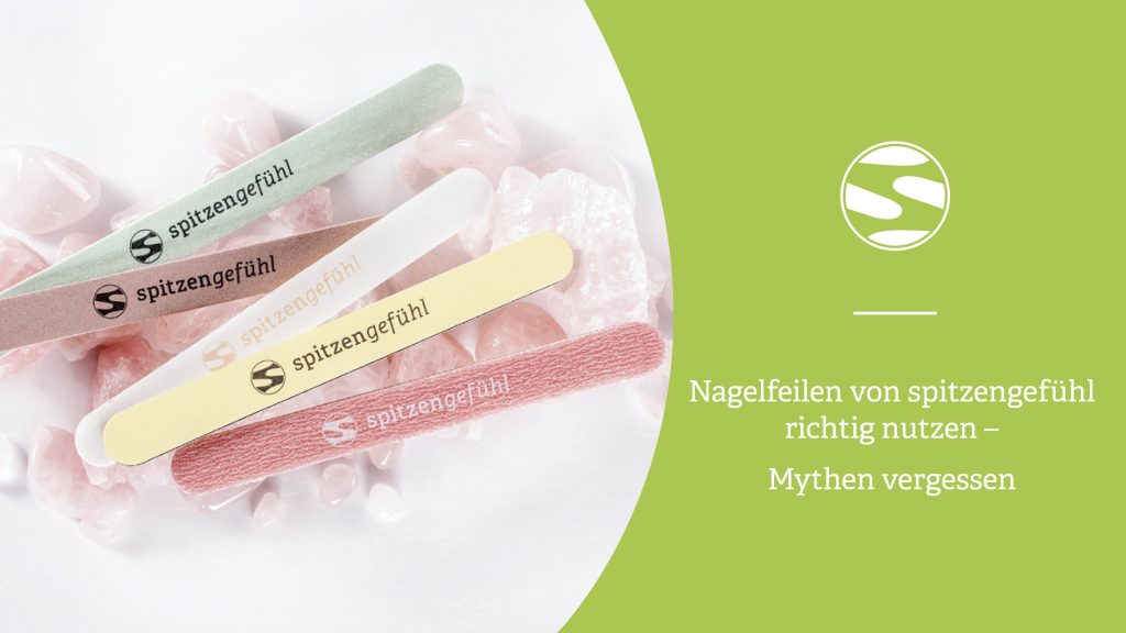 Verschiedene Spitzengefühl Nagelfeilen auf Rosenquarz-Steinen, locker angeordnet.