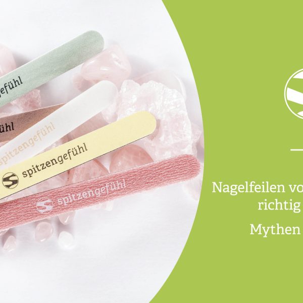 Verschiedene Spitzengefühl Nagelfeilen auf Rosenquarz-Steinen, locker angeordnet.